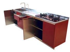 Elegantly designed kitchen cabinet with glass topped stove and sink attached to it.